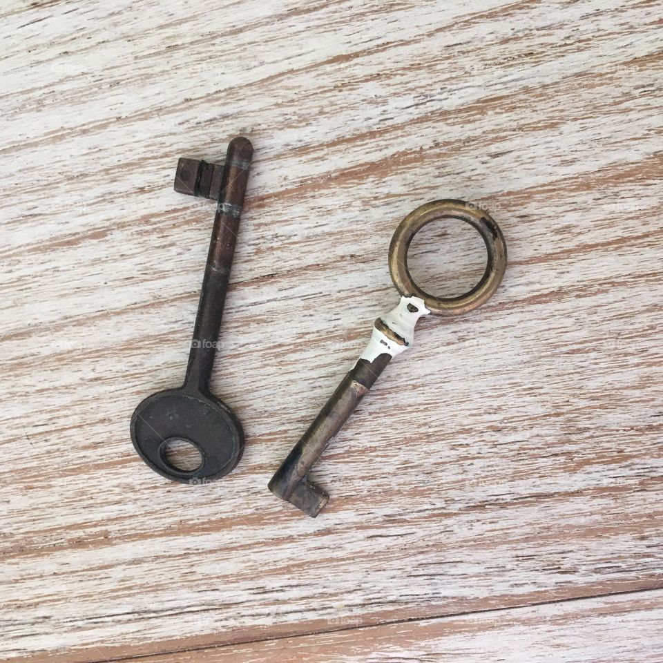 Old metal keys on wooden table