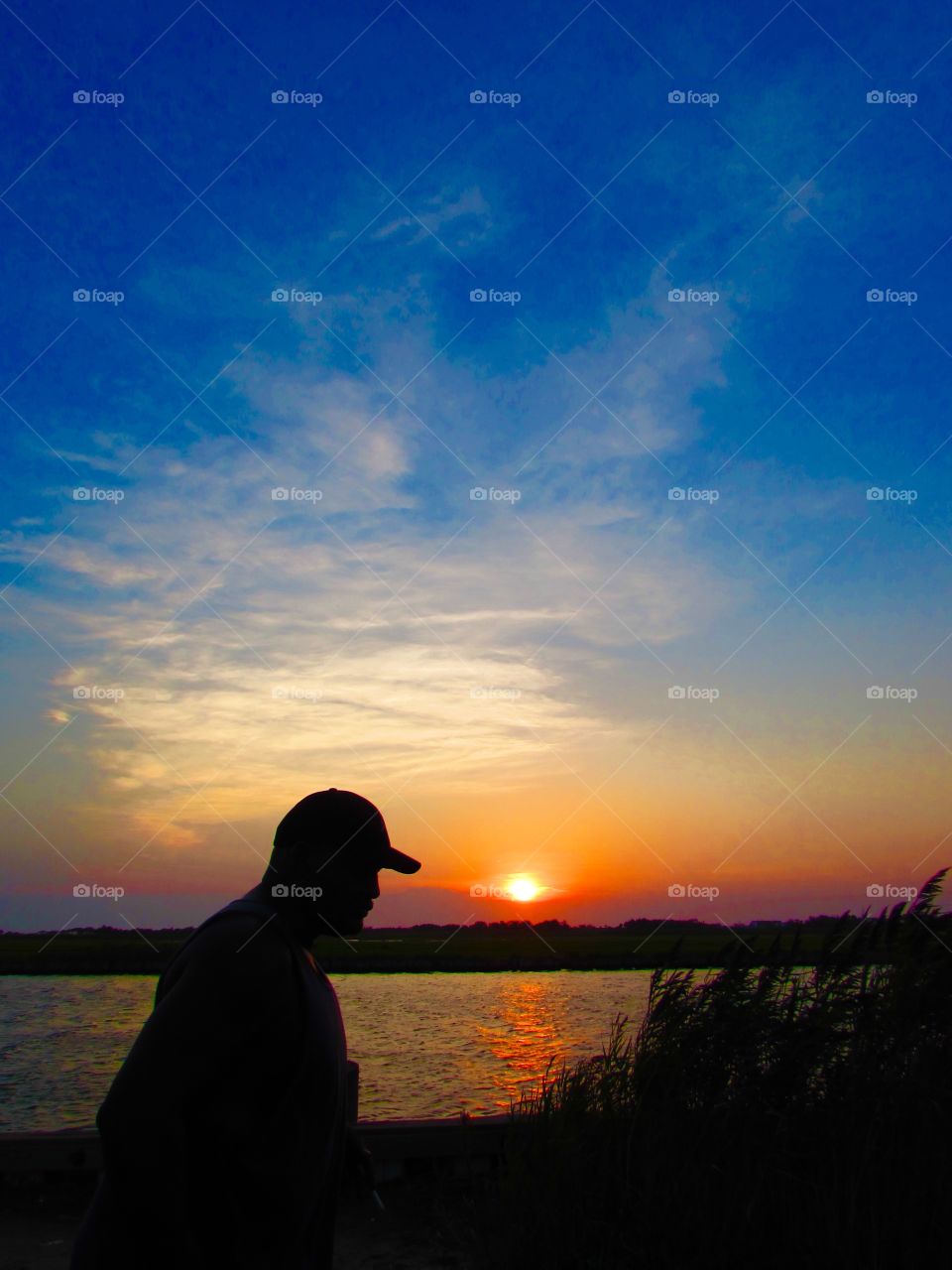 Silhouette of a man walking on the beach