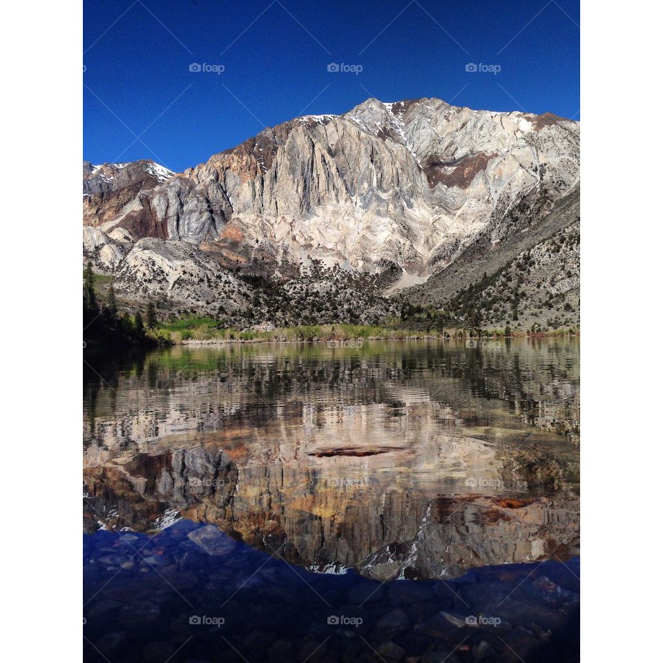 Rocky mountains reflecting on lake