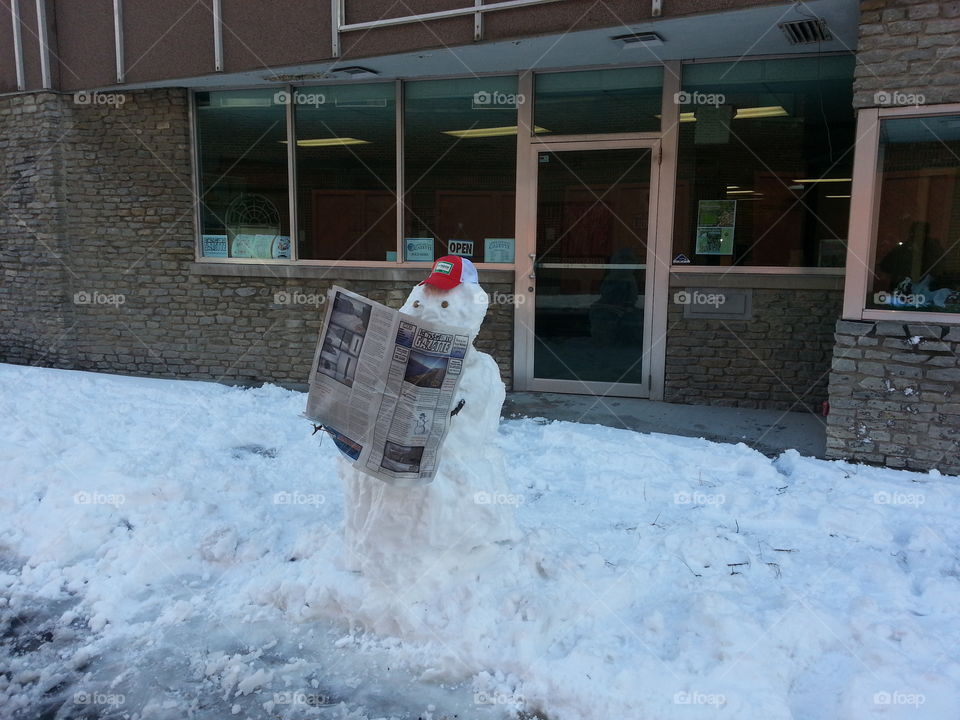 snowman. snowman reading the paper on a cold day