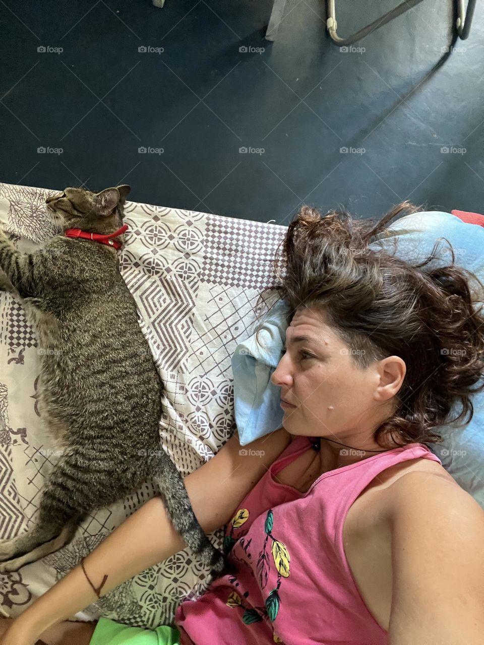 Woman and cat relaxing in the bed 