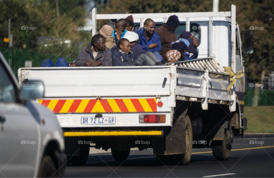 Workers  in South African bakkie