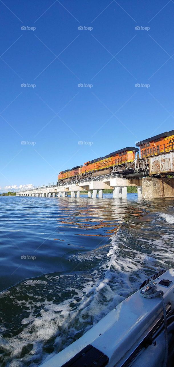 cruisin under the bridge as the train goes by