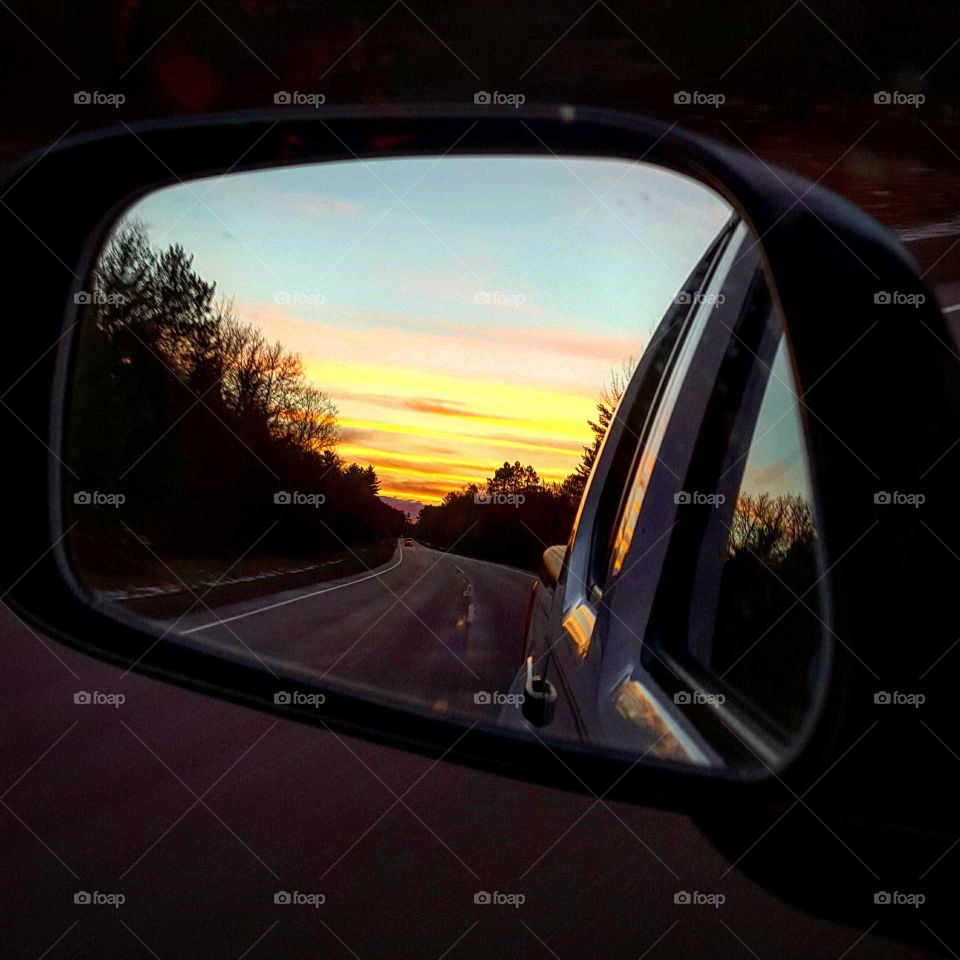 absolutely stunning Northwoods sunset at dusk in car mirror