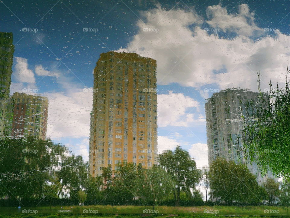 mirror image of houses in the lake of the park of the city of Kiev