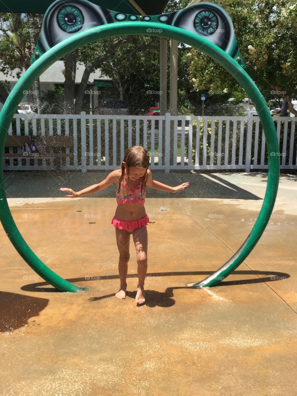 Little girl playing at a water park