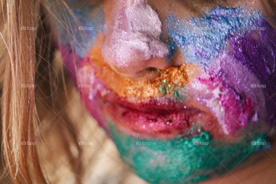 A child wearing glitter makeup