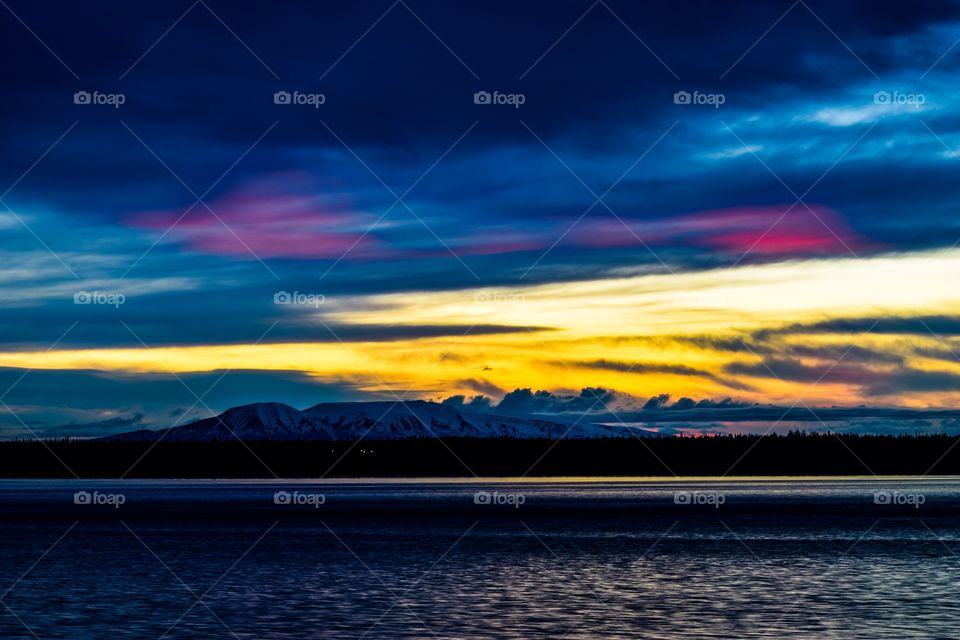 A beautiful sunset over the Sleeping Lady(Mt. Susitna) down by the port of Anchorage, Alaska