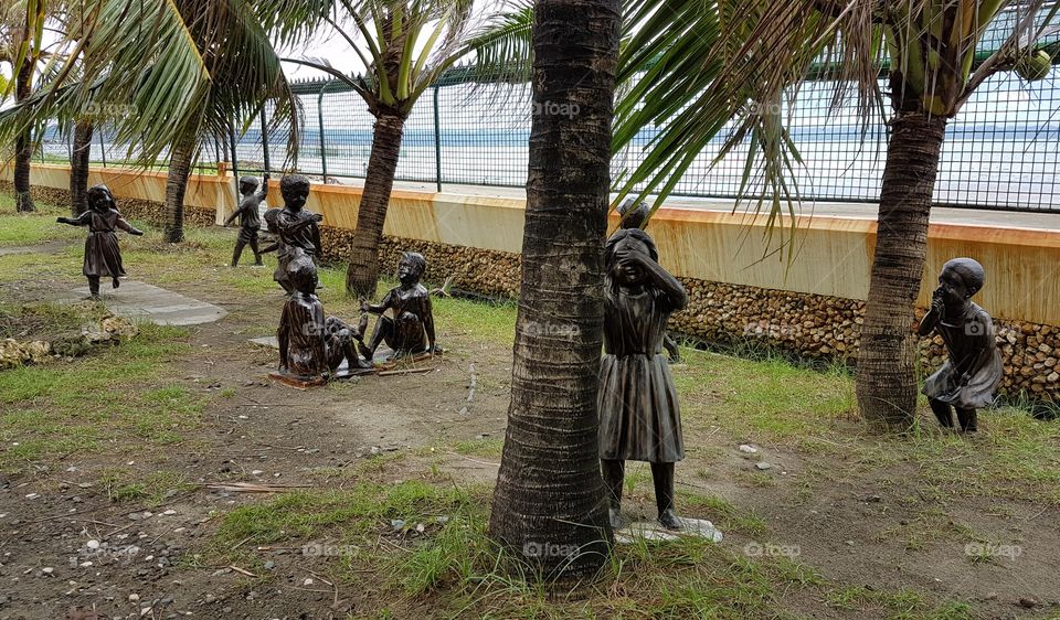 statues of children playing filipino games