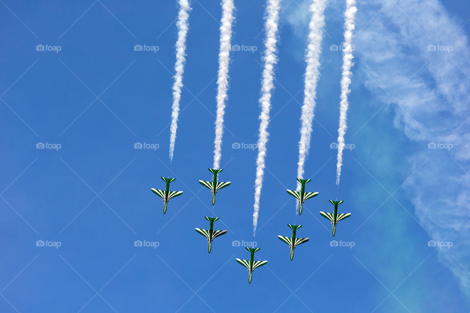 Aerobatic team flying in formation high in the blue sky