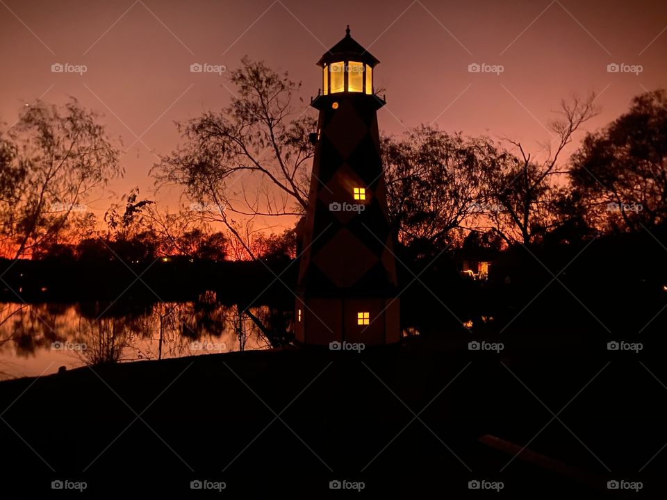 Lighthouse gleaming with multiple accents twilight is activated from Sunset to edging closer to Night. 