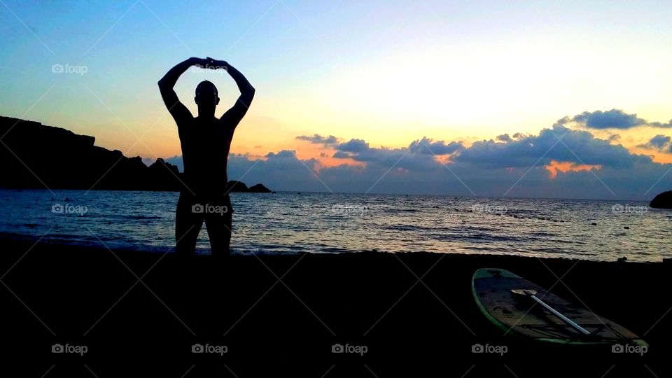 yoga on the beach at sunset