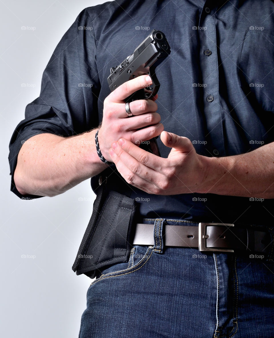 Man reloading pistol after shooting