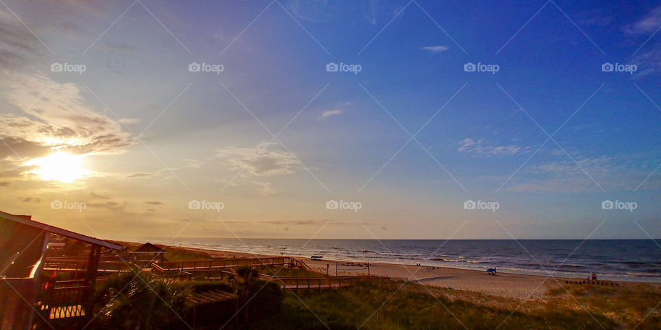 Sunrise and sky at dawn over North Carolina beach.