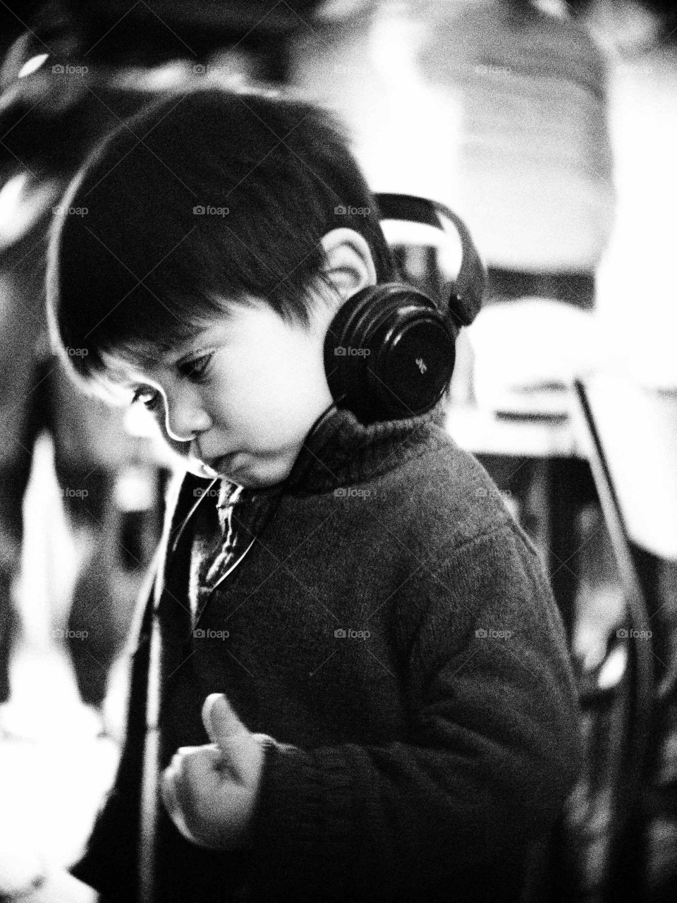 Cute boy listening music by headphones