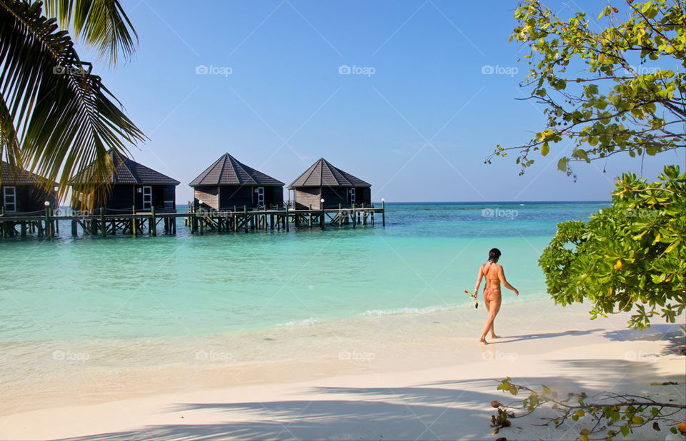 WOMAN ON TROPICAL BEACH