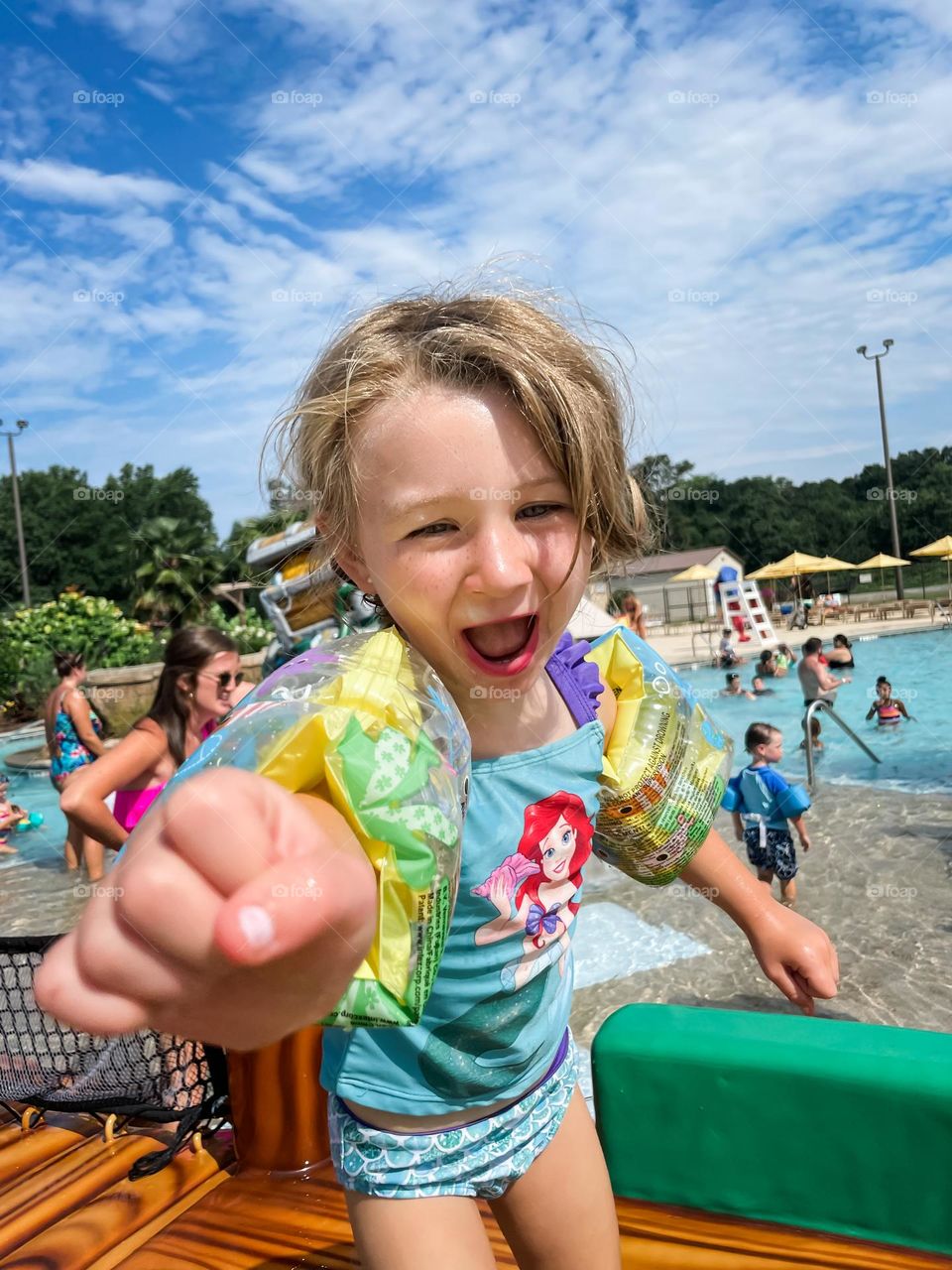 A little girl playing at a water park 