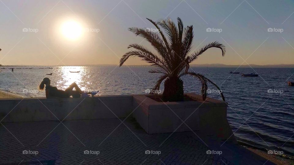 Girl watching the summer sunset 