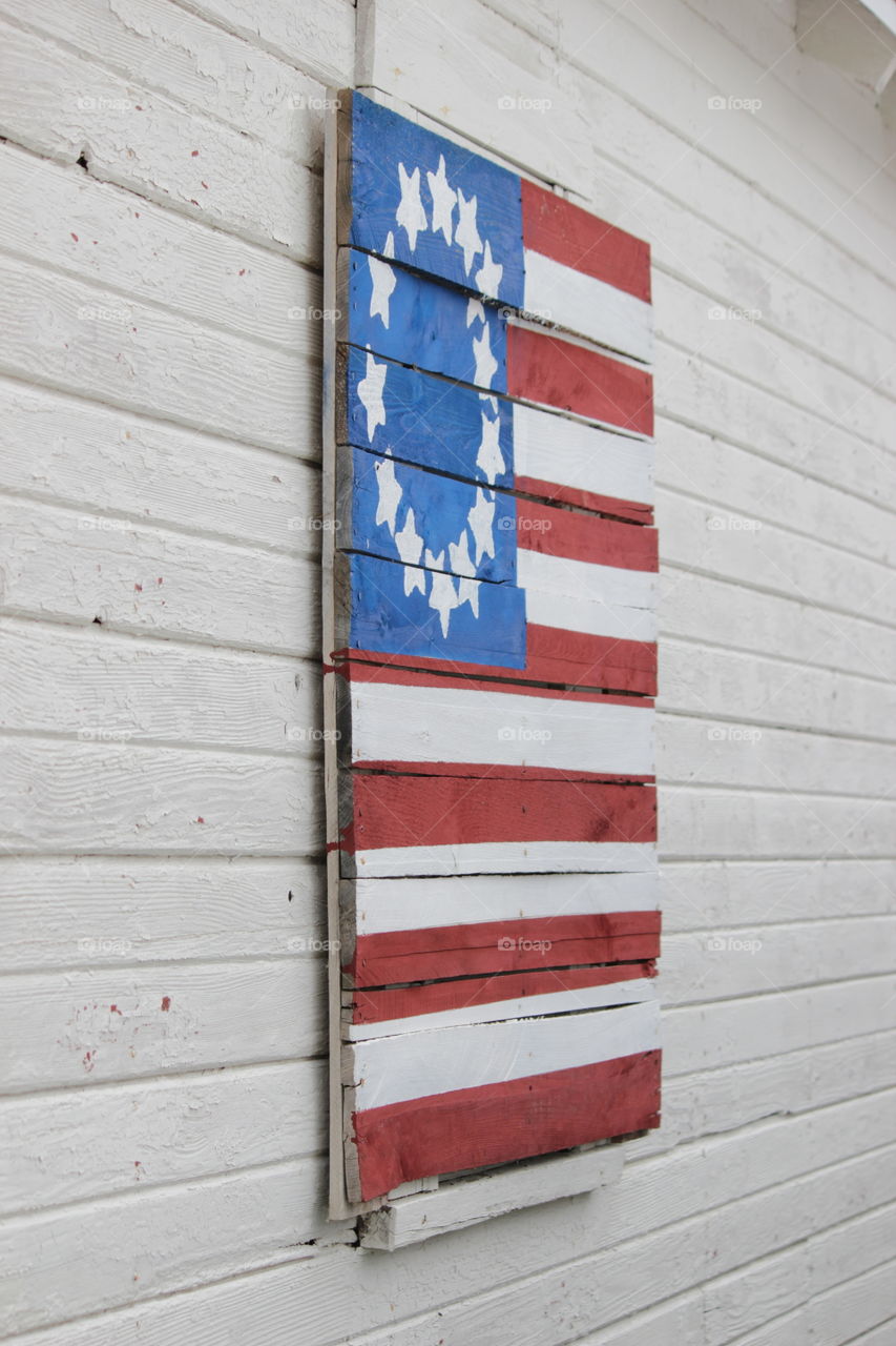 Boards on garage window painted as American flag