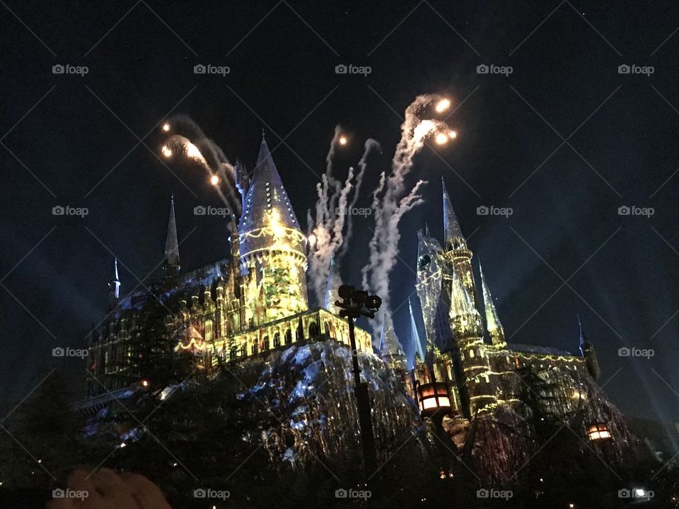 Universal studios light show from the Harry Potter world exhibit over the hogwarts castle 
