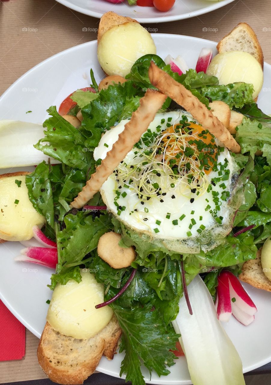 Arugula with fried egg on plate