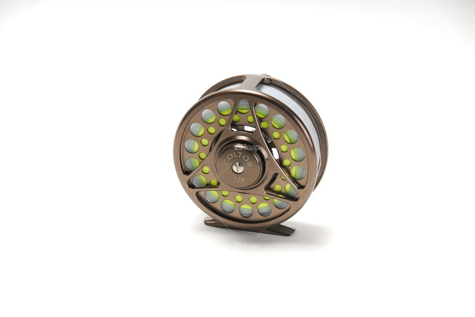 High key white background, studio shot of custom fishing fly wheel
