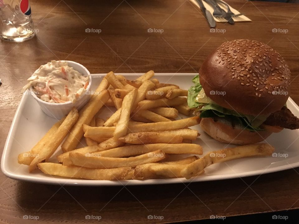 Incredible chicken burger with a side of chips and crispy Coleslaw