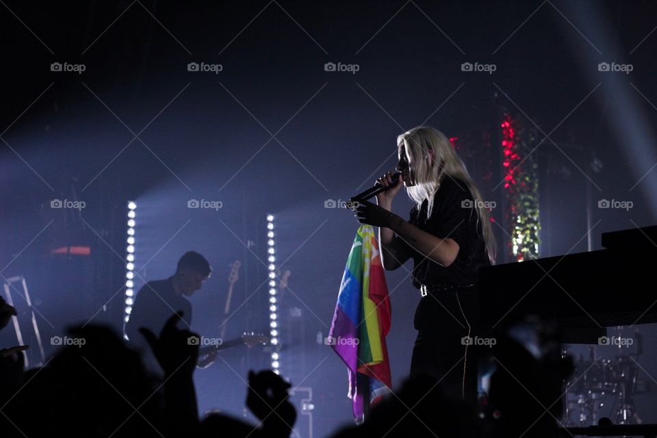 Musician Singing and Holding the Pride Flag