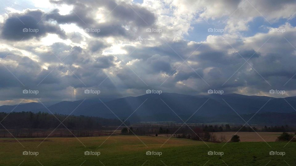 Scenic view of cloudscape over grassy field