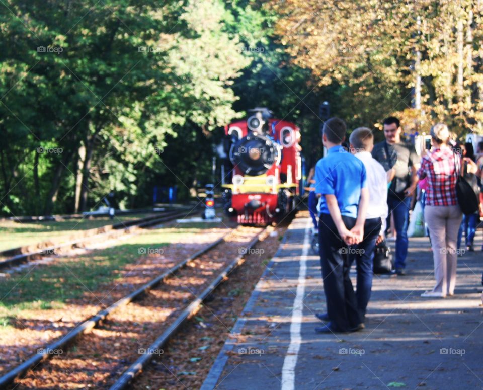 The train arrives at the station. Railway for children in the park