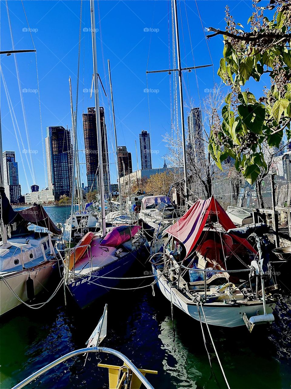 This is „Newtown Creek“ by the „Pulaski Bridge“ in LIC, Queens with its great variety of boats that are tied to the shore here to a tree lined strip of land. 2023 Hypnotic Productions