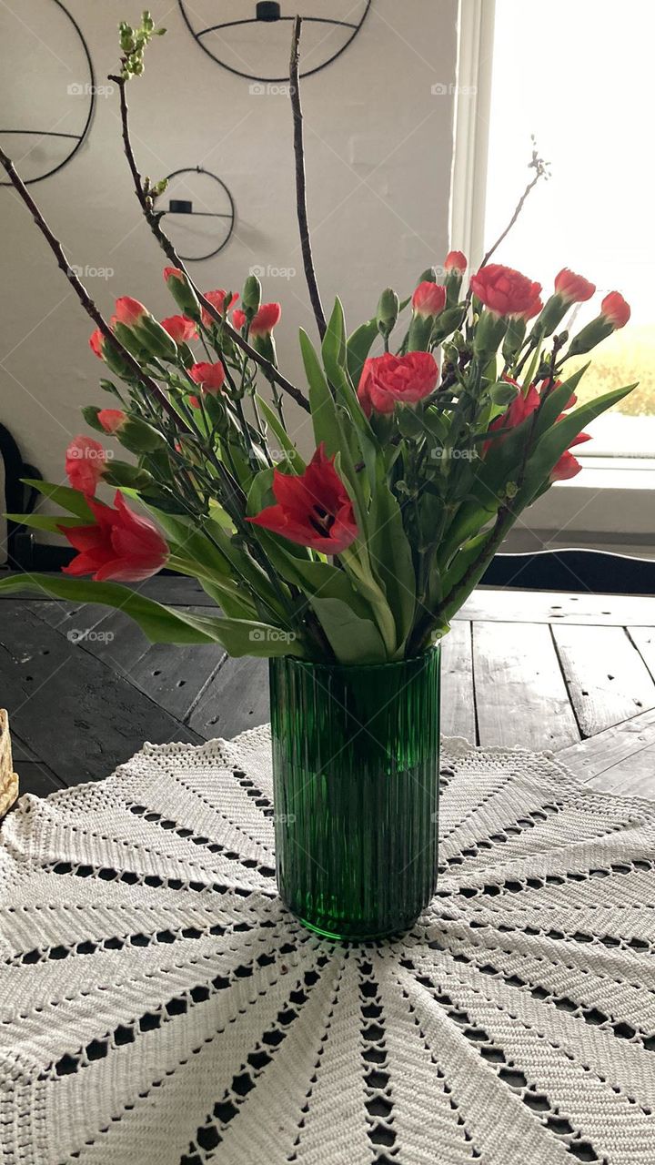 the first spring flowers on the table in a vase