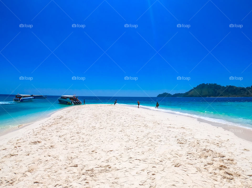 Tourists on Beautiful beach ,sea and blue sky in the southern of Thailand
