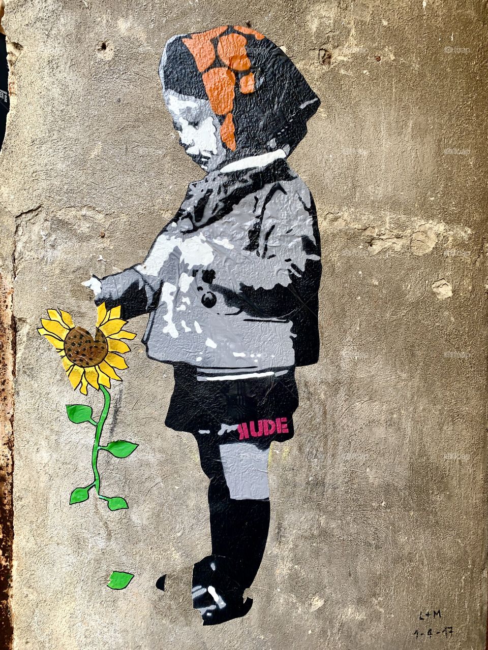 beautiful street art work by RUDE in a street in Florence