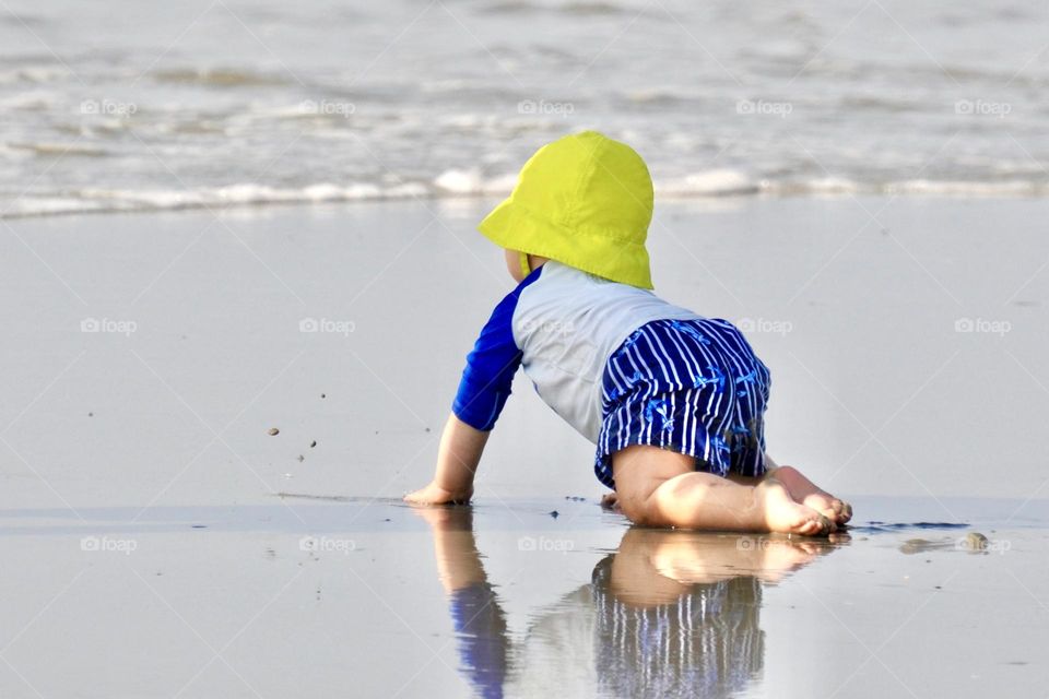 Baby crawling on the beach 