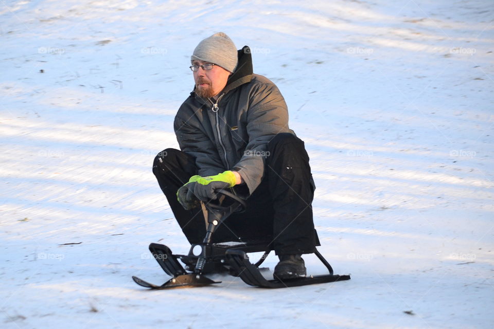 Man sledding in winter