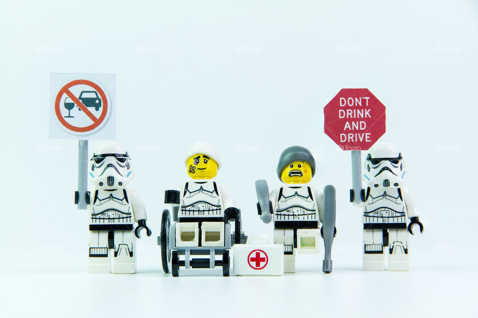 Lego star wars stand holding a sign Drink don't drive and Lego accident by a drunk driver. isolated on white background.Lego is an interlocking brick system collected around the world.