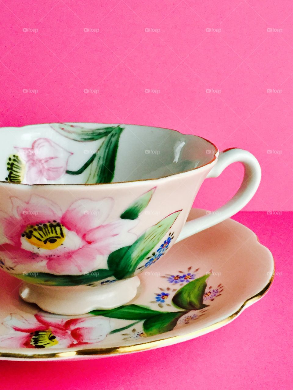 Floral pattern cup and saucer with pink background
