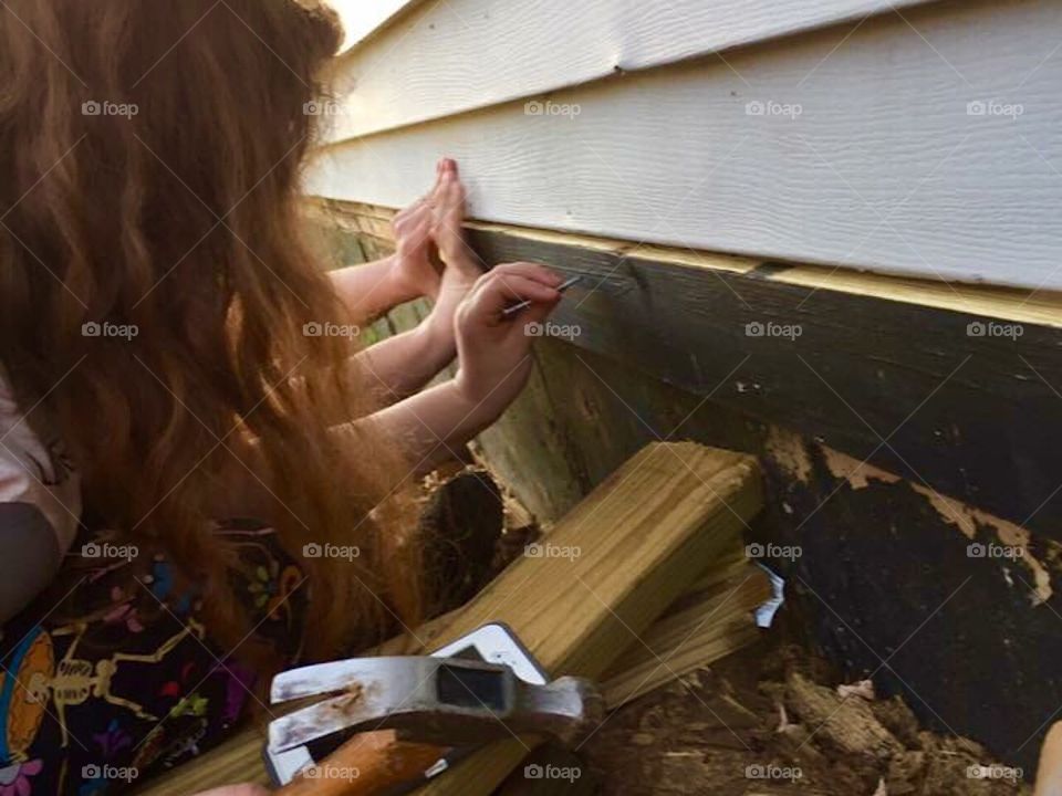 Single parent, family helping to fix carpenter ant damage.
