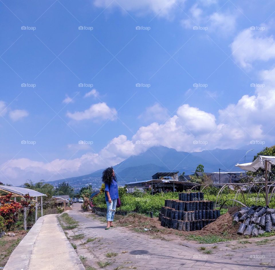 enjoying the sunshine in summer while gazing at the plantation in East java Indonesia