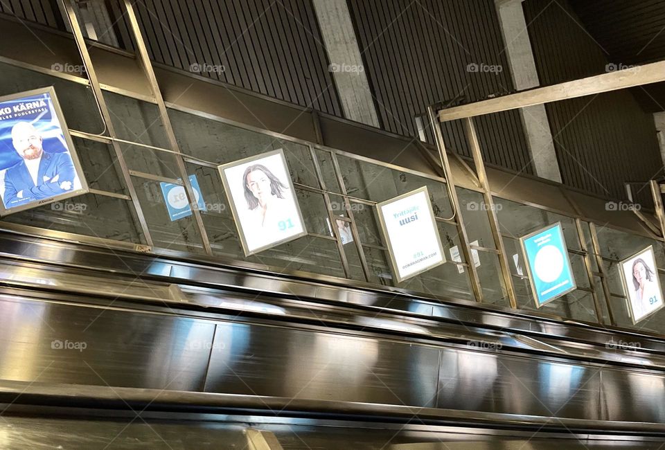 Election ads on the walls of subway escalators.