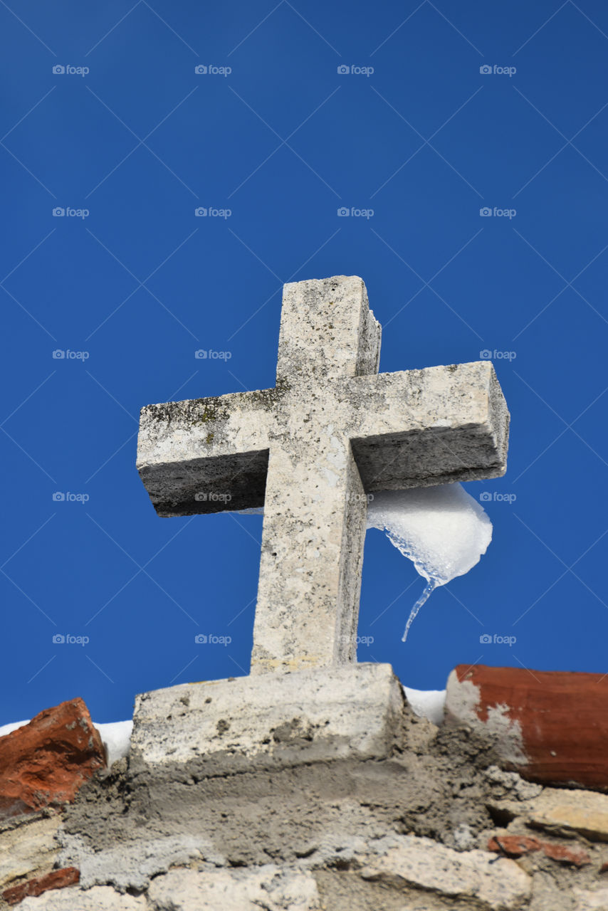 Travertine iced cross, San Lorenzo church, Paggese, Italy