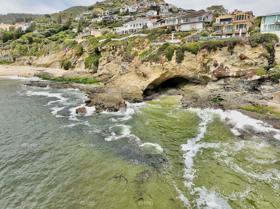 The beautiful cliffs of Laguna beach California as the mighty Pacific Ocean waves crash into the rocky cave 