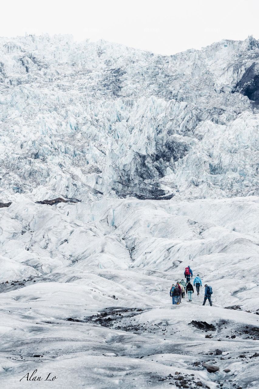 A small team exploring the Glacier in Iceland