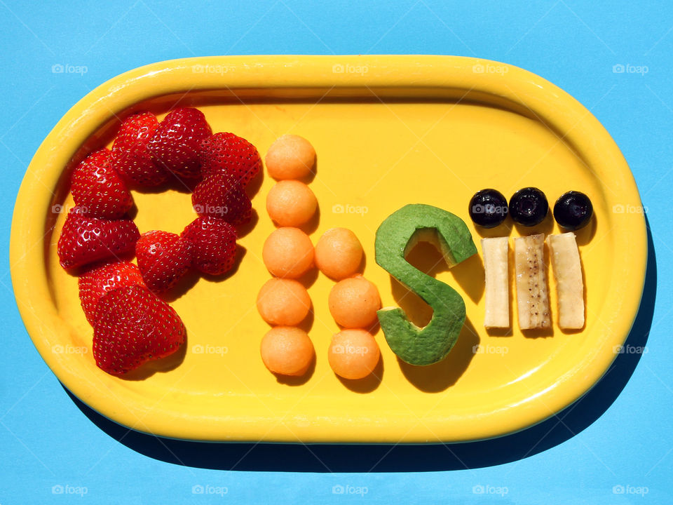 Some colourful edible self-promotion! Why not?! My FOAP name, Phsiii, in strawberries, cantaloupe, avocado, banana & blueberries on a bright yellow plate & a sky blue background.