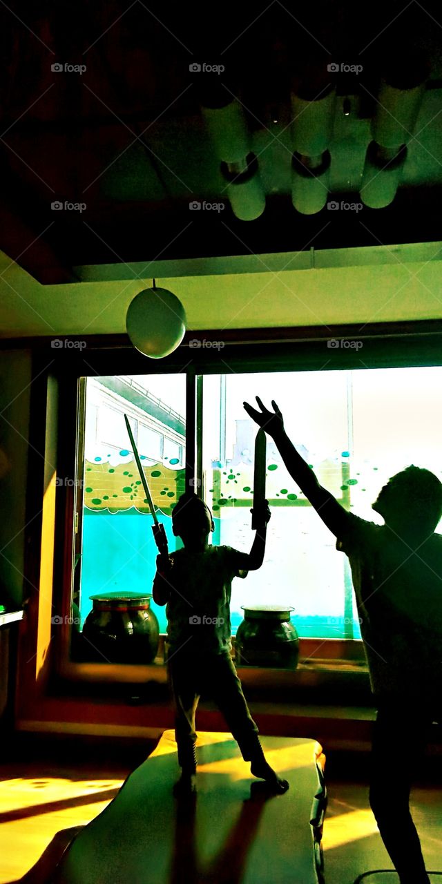 The Flying Balloon and the Two people who wants to hit and catch it inside the living room in South korea.