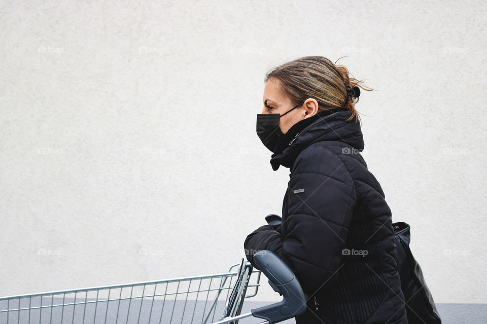 A woman with a shopping cart