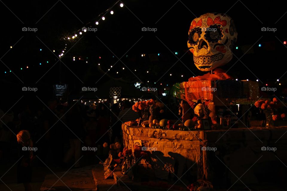The central decoration of the Día de los Muertos celebration in San Antonio, Texas is a skull atop a fountain. The lights and colors are as festive as they are an appropriate memorial for souls of days past.