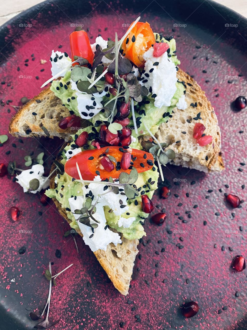 Smashed Avocado, Feta, Multigrain Bread and pomegranate. Yum! 