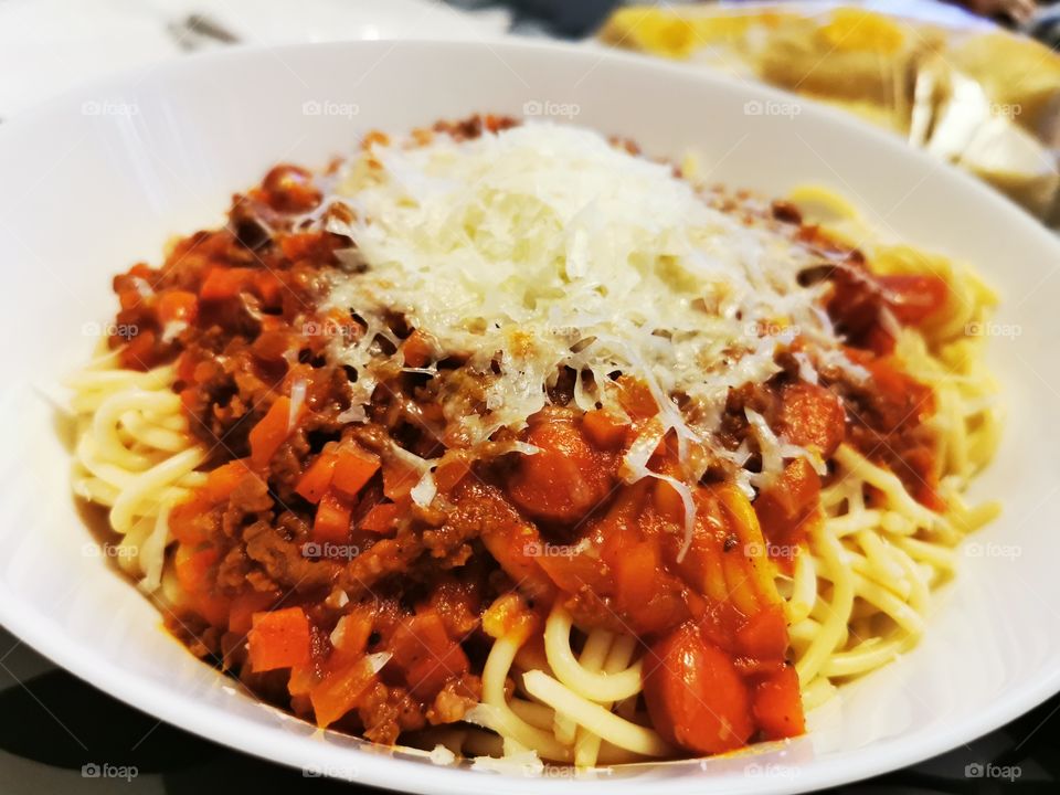 From scratch spaghetti sauce with cheese on top.